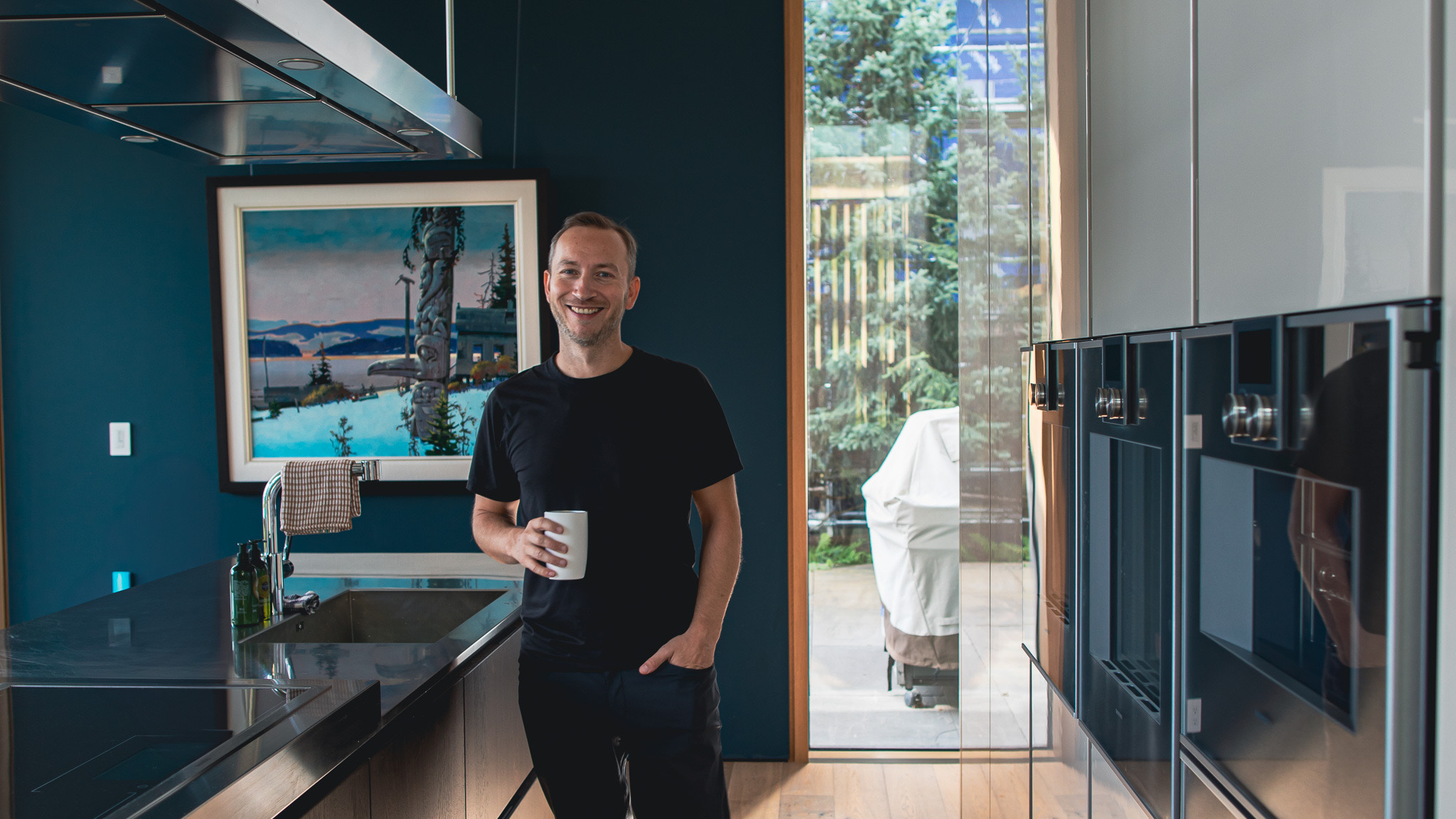 Morgan Maryk in a modern kitchen, holding a mug